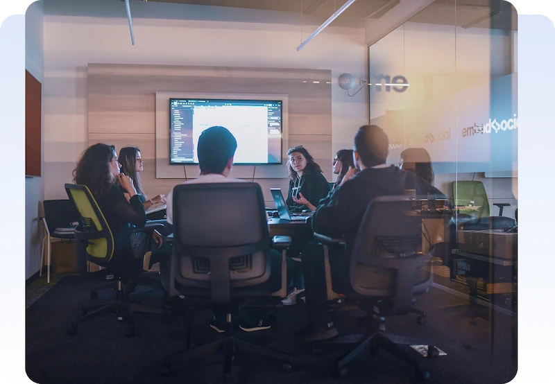 IT Consulting Technology Team collaborating during a meeting in a modern conference room.