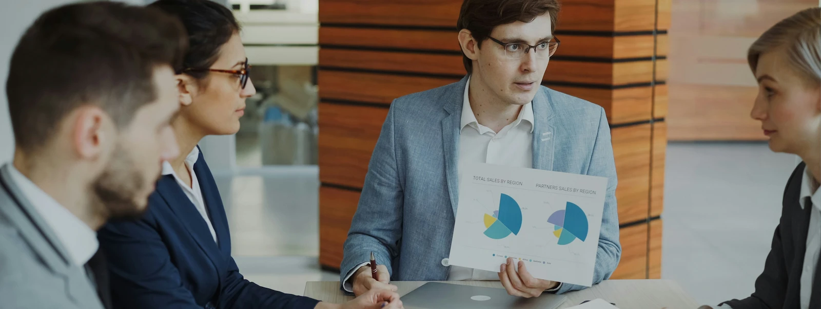 Business team reviewing sales charts during a meeting.